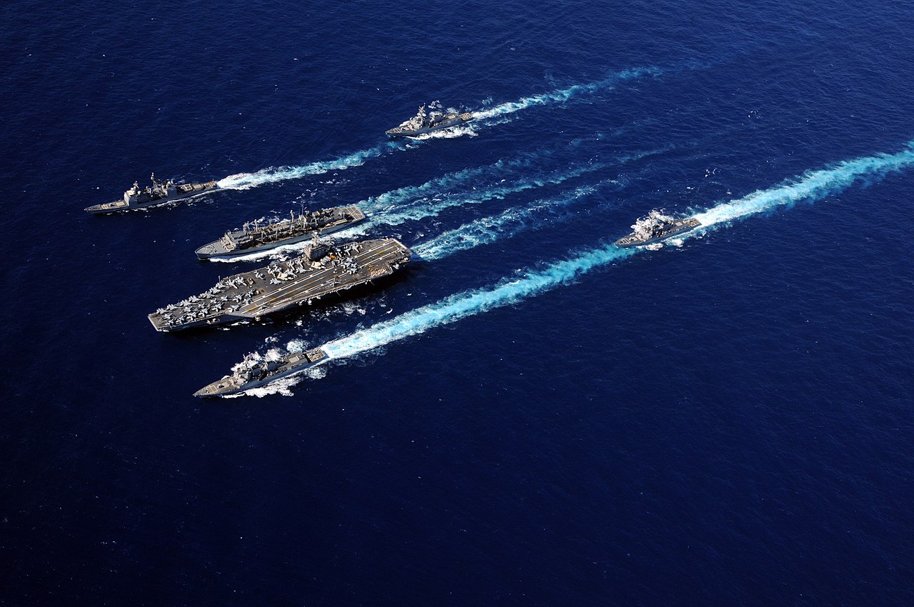 1280px-US_Navy_100919-N-5226D-141_The_Abraham_Lincoln_Carrier_Strike_Group_ships_cruise_in_formation_during_an_underway_replenishment_with_the_Military_Se.jpg