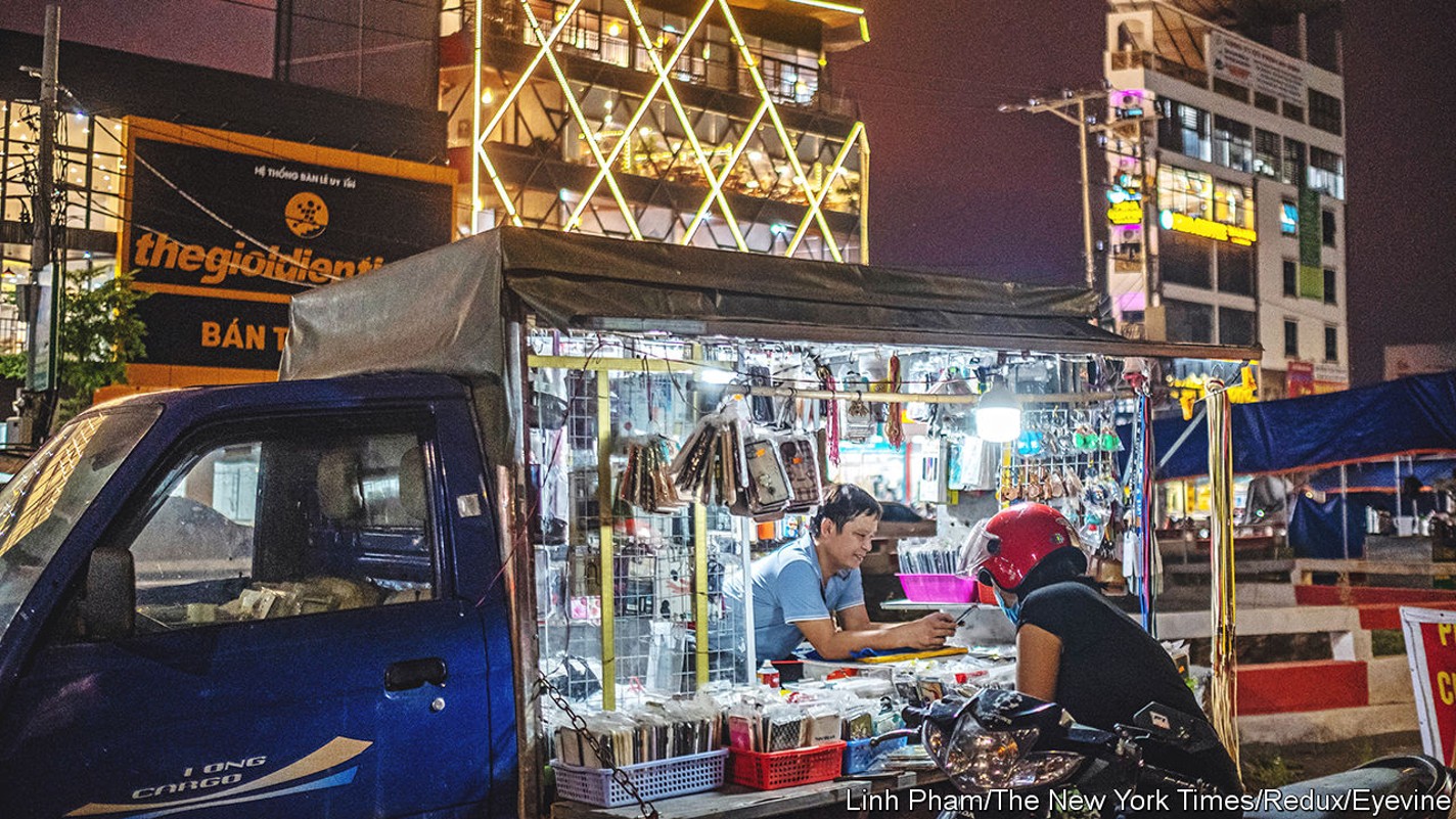 A factory worker shops for phone accessories after work in a newly-built neighborhood near the Van Trung Industrial Park, in Bac Giang province, Vietnam, Aug. 20, 2022. Worried about geopolitical tensions and stung by pandemic shutdowns, Google, Apple and others are moving some work to nearby countries. (Linh Pham/The New York Times)Credit: New York Times / Redux / eyevineFor further information please contact eyevinetel: +44 (0) 20 8709 8709e-mail: info@eyevine.comwww.eyevine.com