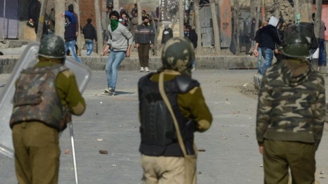 Kashmiri demonstrators throw rocks at Indian police as they clash during a strike in downtown Srinagar on March 4,2013.