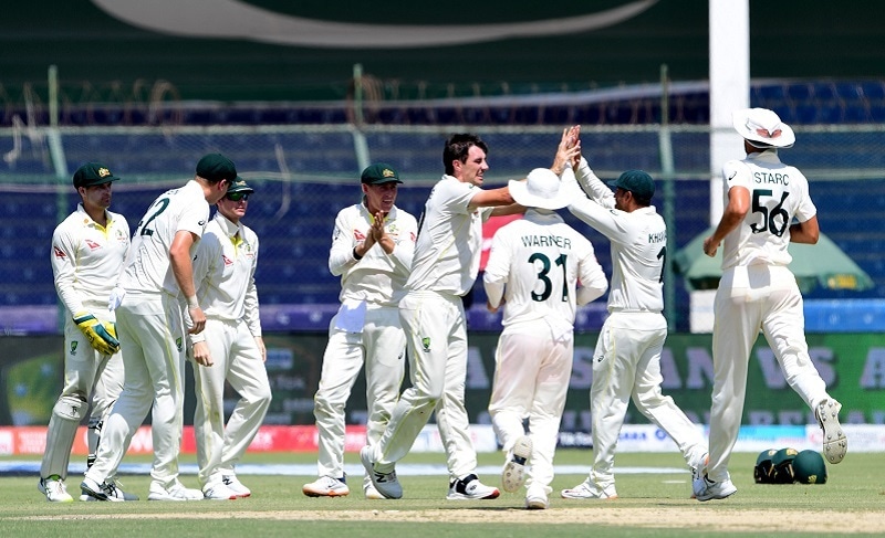 Australia's Pat Cummins (C) celebrates with teammates after the dismissal of Pakistan's Abdullah Shafique (not pictured) during the fifth and last day of the second Test match between Pakistan and Australia at the National Cricket Stadium in Karachi on Wednesday. — AFP