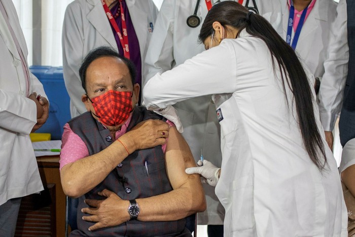 Harsh Vardhan, health minister, receives a vaccine, developed by Indian company Bharat Biotech, at a private hospital in New Delhi in March