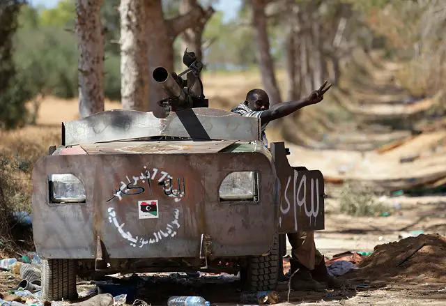 Libyan_rebel_fighter_in_a_vehicle_rigged_with_armour_plates_13_June_2011_near_Zlitan_001.jpg