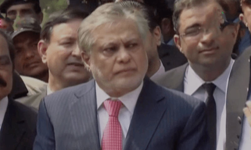 Finance Minister Ishaq Dar talks to media outside an accountability court in Islamabad on Wednesday. — DawnNewsTV