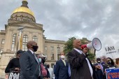 African Methodist Episcopal Church Bishop Reginald Jackson announces a boycott of Coca-Cola Co products outside the Georgia Capitol as Georgia legislators vote to approve new voting restrictions likely to disenfranchise Black voters [Jeff Amy/AP Photo]