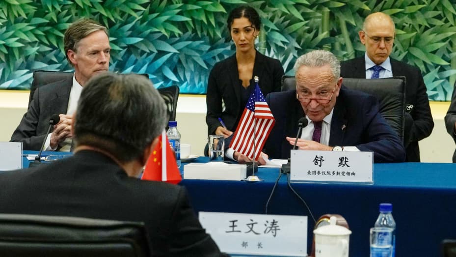 US Senate Majority Leader Chuck Schumer (R) attends a bilateral meeting with Chinese Commerce Minister Wang Wentao (front L) at the Ministry of Commerce in Beijing on October 9, 2023.