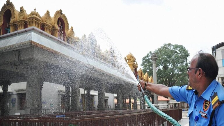 Guard cleans karnataka temple with pipe water