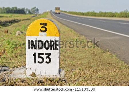 stock-photo-horizontal-capture-of-kilometers-to-indore-milestone-on-the-national-highway-from-bombay-to-115183330.jpg