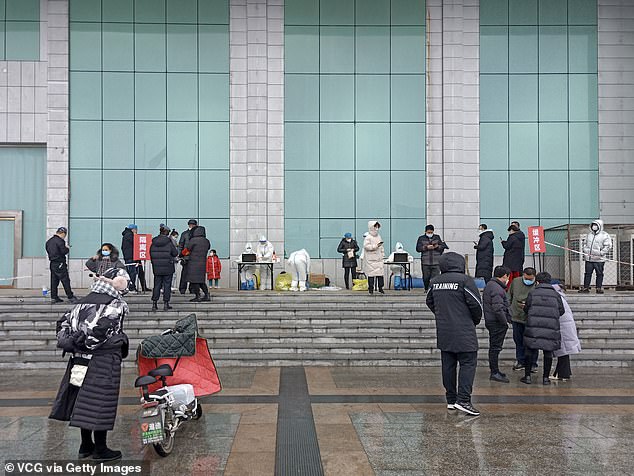 Around 1.2m people in Xiong'an are no longer allowed to enter or leave their residential compounds. Pictured: People receive Covid-19 nucleic acid test at a testing site in Anxin County on January 23