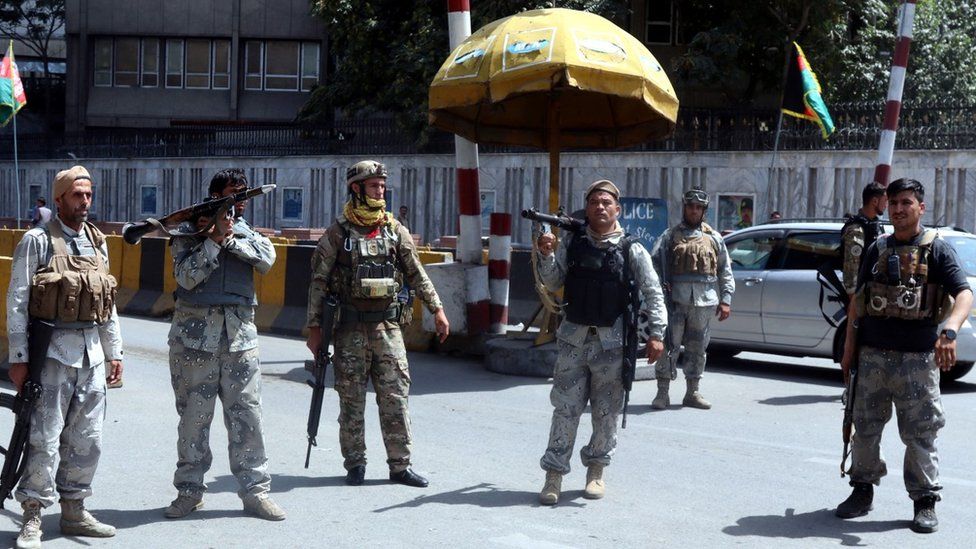 Afghan security officials stand guard at a checkpoint in Kabul, Afghanistan, 15 August 2021
