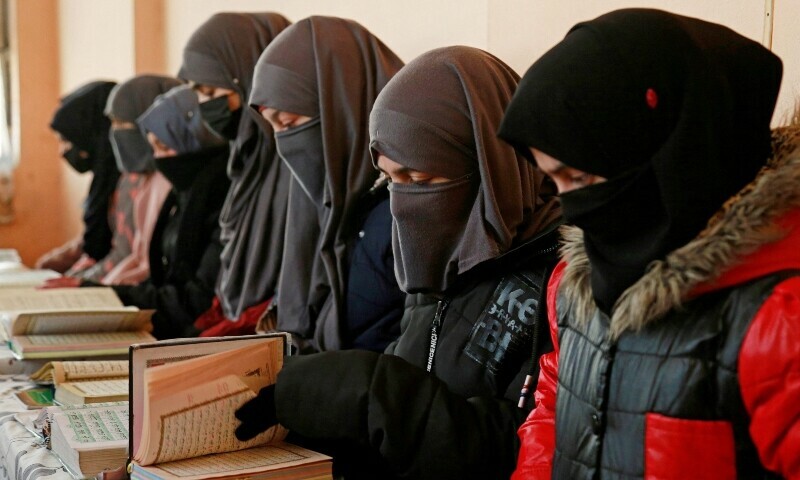 <p>Afghan girls learn the holy Quran at a madrassa or an Islamic school on the outskirts of Kabul. — AFP</p>