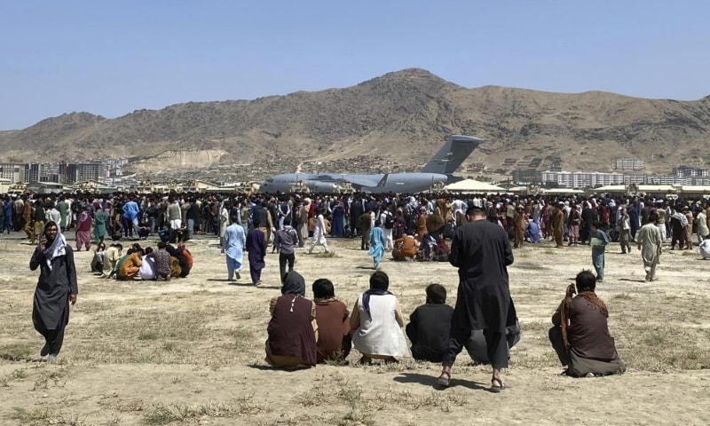 Hundreds of people gather near a US Air Force C-17 transport plane at a perimeter at the international airport in Kabul, Afghanistan, on August 16. — AP