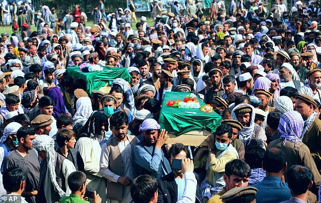 Afghans carry the body of civilians killed during fighting between the Taliban and Security forces, during their funeral, in Badakhshan province, northern Afghanistan, Sunday