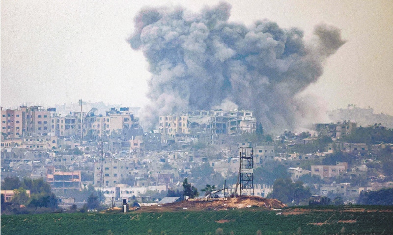 GAZA STRIP: A plume of smoke ascends following Israeli bombardment over the northern Gaza Strip, on Friday.—AFP