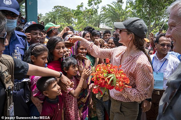 57132267-10761073-Crown_Princess_Mary_shook_the_hands_of_locals_and_graciously_wav-a-1_1651102587423.jpg
