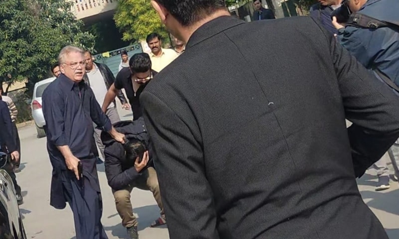 A photo of media personality Mohsin Jamil Baig holding a gun in an altercation with FIA officials in Islamabad on Wednesday. — Photo by author