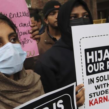 Women in masks holding up protest signs