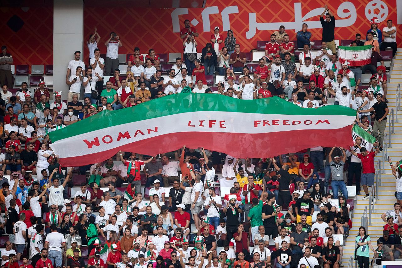 Iranian fans hold up a sign that reads Woman Life Freedom during the match against England on Monday. Anti-government protests have entered a third month back in Iran. Outside the stadium before the game, CNN witnessed a number of Iran supporters <a href=https://www.cnn.com/sport/live-news/world-cup-11-21-22/h_64af1374bbf15fe3487b65c05d1b99b1 target=_blank>wearing protest T-shirts</a>, with slogans such as Free Iran or Rise with the women of Iran.