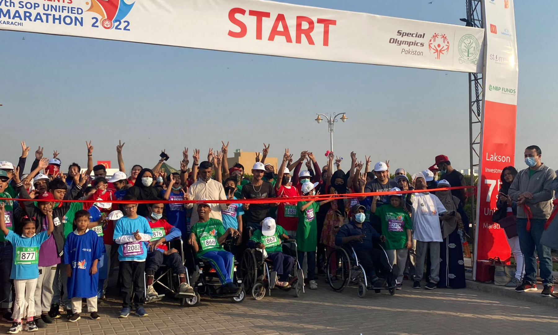 Participants of the 1km Unified Marathon await at the starting line cheering before the race kicks off. — Photos by author