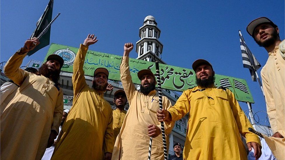Activists of Jamiat-ul-Ulama-i-Islam and supporters of the Pakistan Democratic Movement (PDM) chant slogans as they leave for a rally held in Islamabad to protest against the judiciary's alleged undue facilitation to former Pakistan's Prime Minister Imran Khan, in Peshawar on May 15, 2023.'s alleged undue facilitation to former Pakistan's Prime Minister Imran Khan, in Peshawar on May 15, 2023.