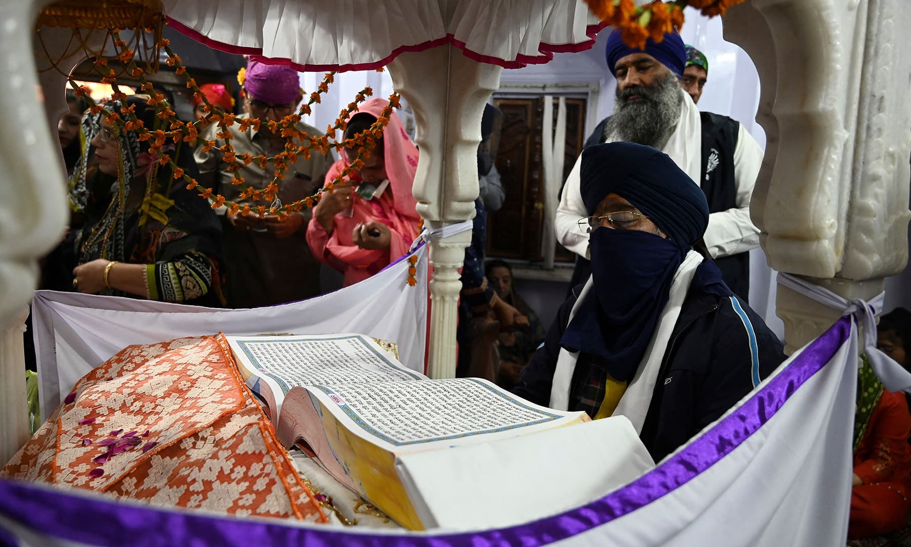 A Granthi or ceremonial reader recites the Guru Granth Sahib during a religious ceremony on the occasion of the birth anniversary of Guru Nanak Dev in Nankana Sahib. — AFP