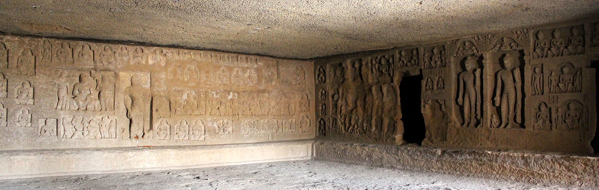 1920px-Kanheri_cave_90_back_and_right_sculpture_walls.jpg