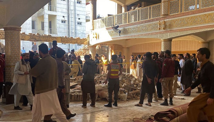 Security officials inspect the site of a mosque blast inside the police headquarters in Peshawar on January 30, 2023. — AFP