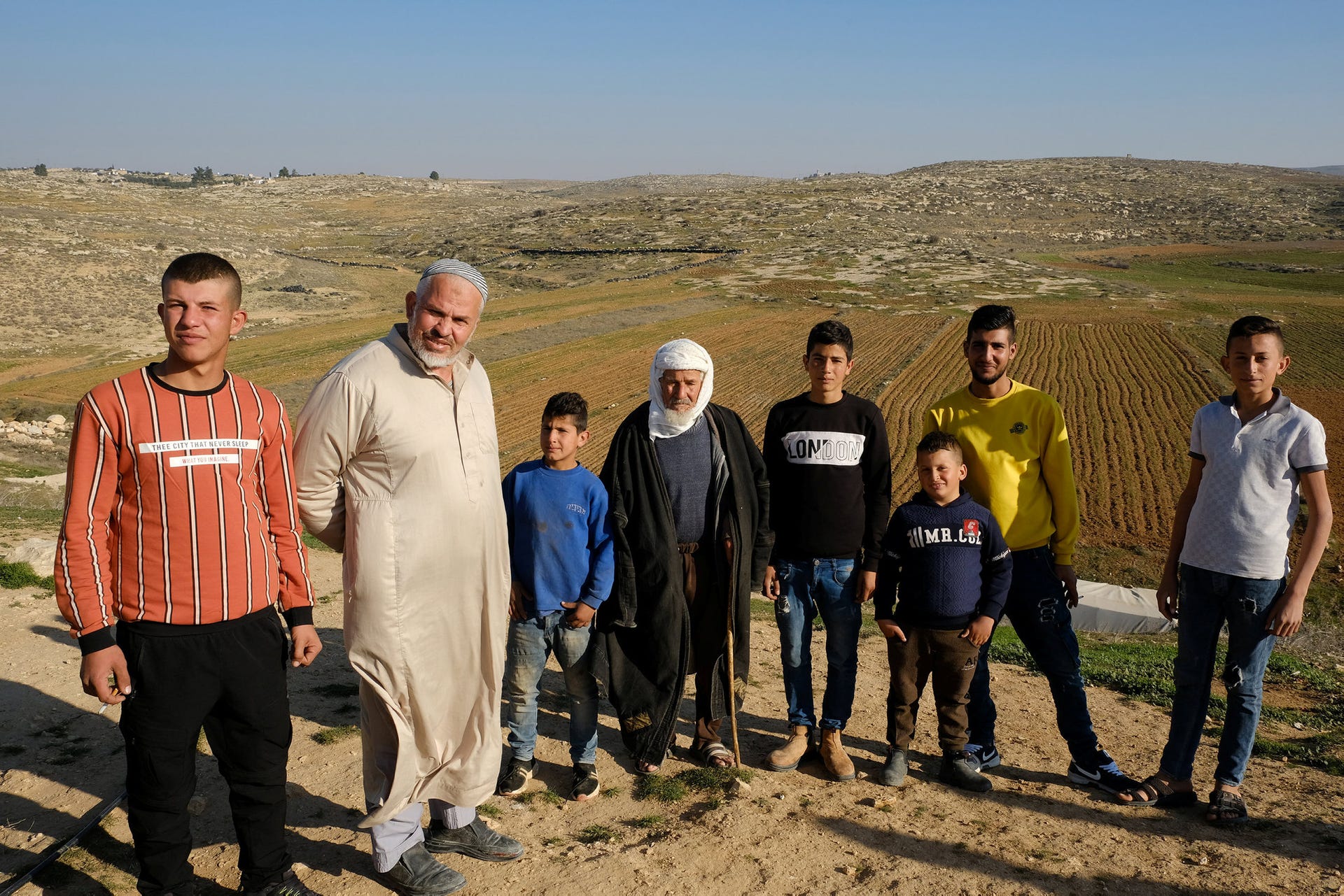 The Haraini family in Yatta. Their field is behind them. 