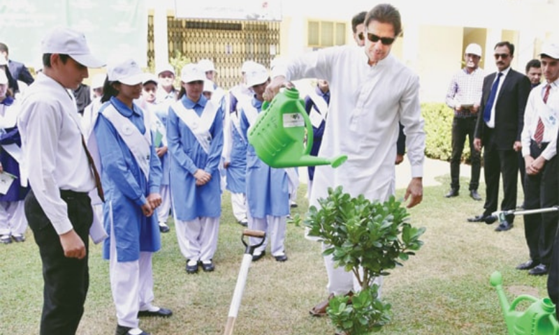 In this file photo, Prime Minister Imran Khan waters a plant during the launch of ‘Clean and Green Pakistan’ campaign at Islamabad Model College for Girls in Islamabad. — Online/File
