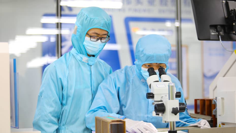 CHONGQING, CHINA - MAY 4, 2023 - Young technicians test the quality of electronic chips at a dust-free production workshop in Chongqing, China, May 4, 2023. (Photo credit should read CFOTO/Future Publishing via Getty Images)