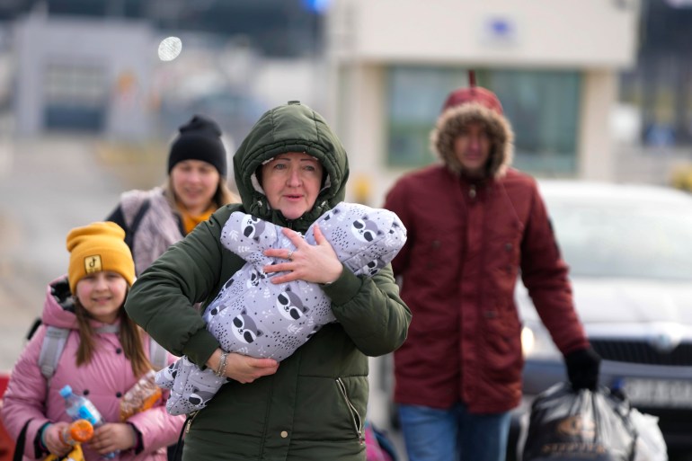 A Ukrainian family arrive at the border crossing in Medyka, Poland