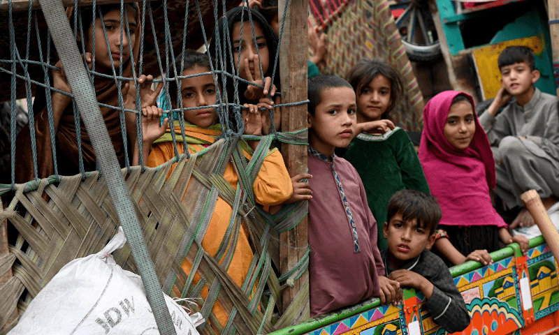  Afghan children refugees arrive on trucks from Pakistan at the Afghanistan-Pakistan Torkham border in Nangarhar province on Nov 1. — AFP 