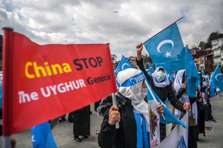 Uighur women gather outside the Chinese consulate in Istanbul to denounce the alleged rights violations of Uighurs in Xinjiang [File: Ozan Kose/AFP]