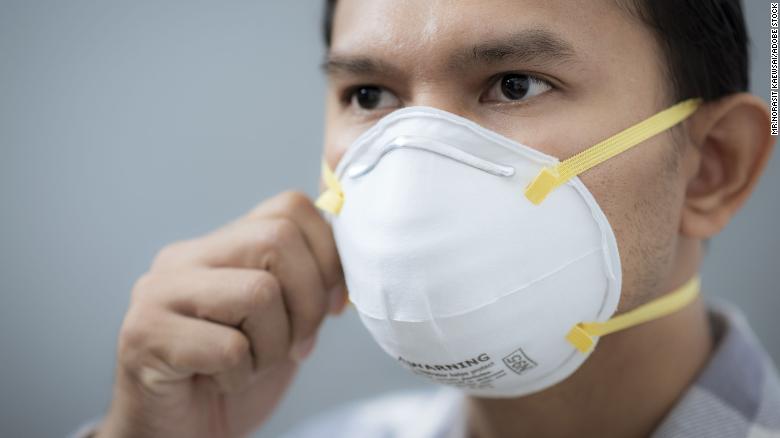 A man wears an N95 face mask.