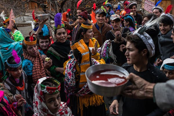 The women dance and sing outside the home of villagers, where they are met with food and homemade mulberry wine. 