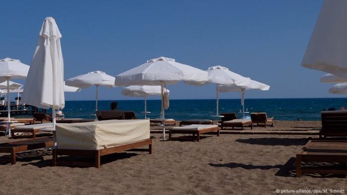 A picture of empty beach chairs lined up on a beach in Turkey's tourism hot spot Antalya