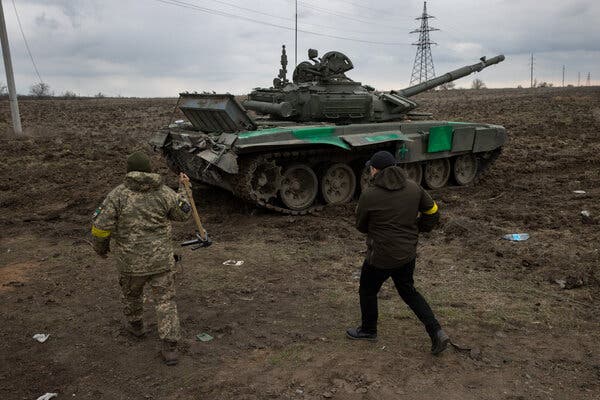 Residents of Mykolaiv, Ukraine, worked to repair a captured Russian tank on Sunday.