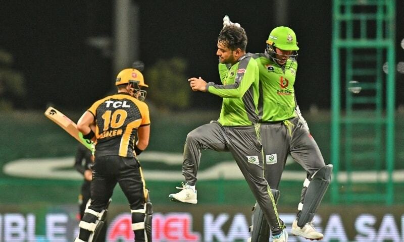 Lahore Qalandars’ spinner Rashid Khan celebrates with Ben Dunk after a dismissal during a HBL PSL 6 match against Peshawar Zalmi in June at the Sheikh Zayed Stadium. – PCB Photo