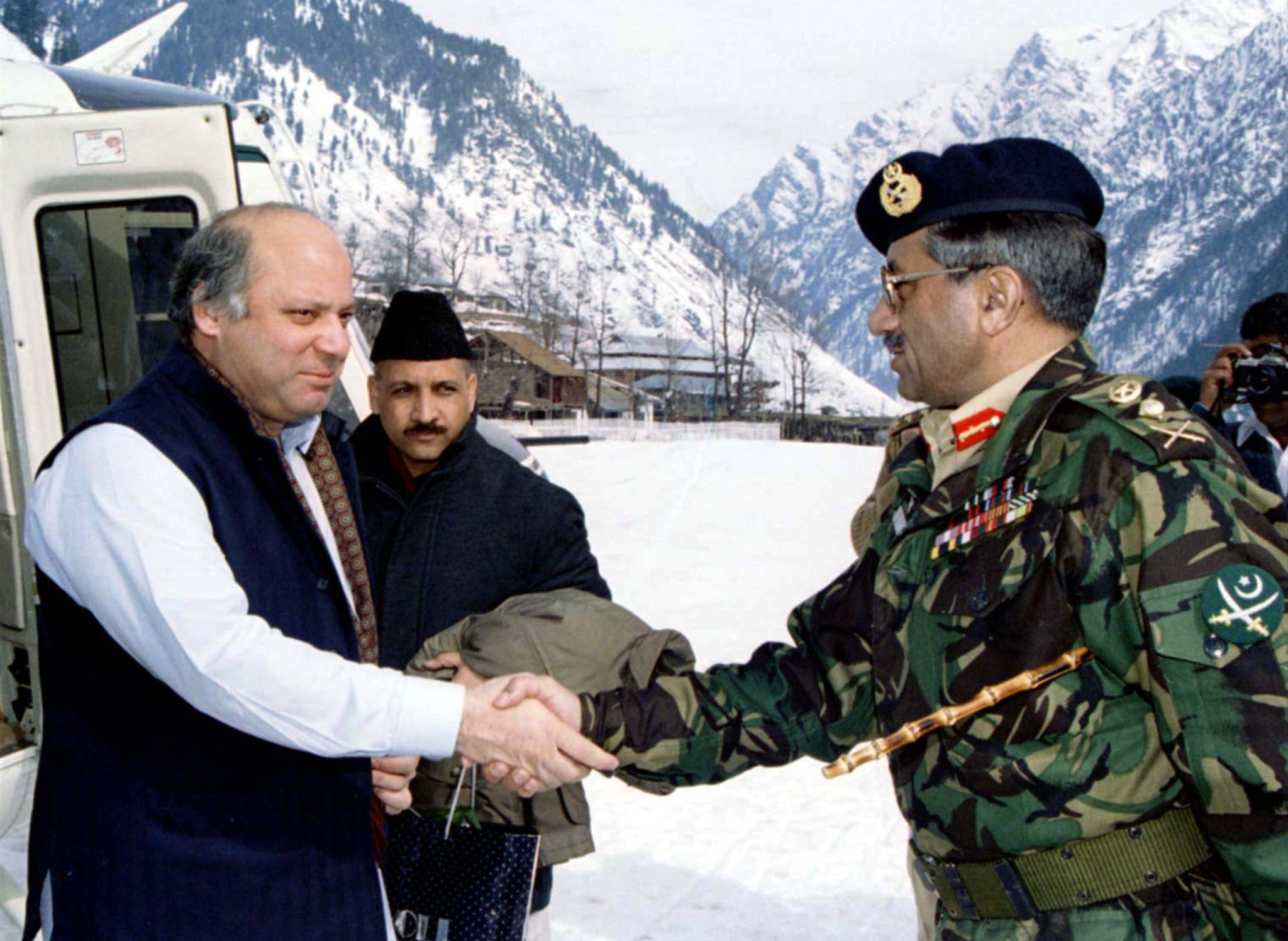Prime Minister Nawaz Sharif is greeted by army chief General Pervez Musharraf on arrival at the snow-clad town of Kail on the border in the disputed Himalayan region of Kashmir in this February 5, 1999 file photo. — Reuters