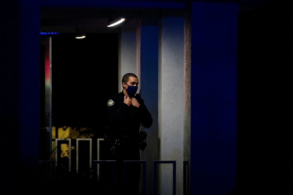 An officer stands outside Gold Spa after a shooting on March 16 in Atlanta. —  AP