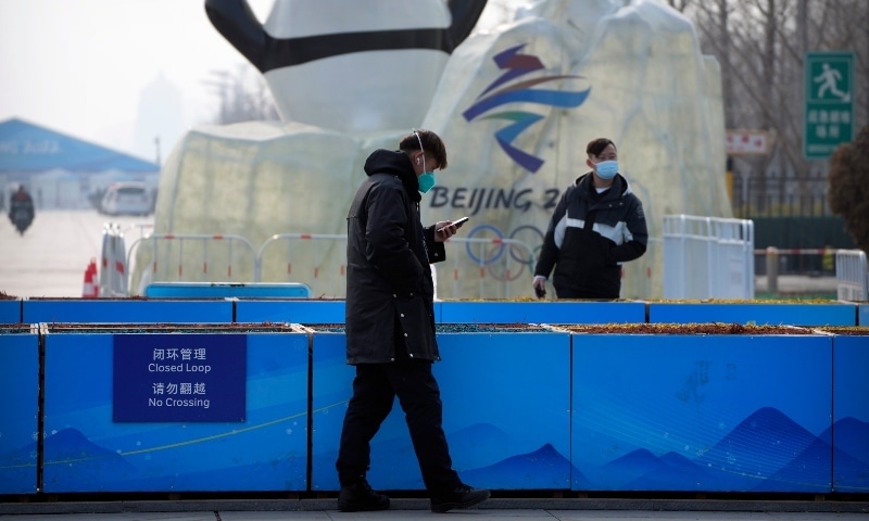 Security officers patrol near the edge of the closed-loop area on the Olympic Green near the main media centre at the 2022 Winter Olympics in Beijing on Jan 30. — AP