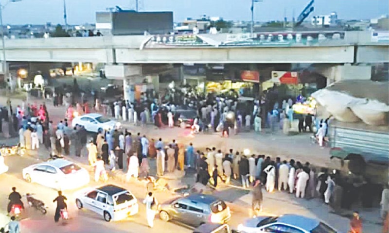 Demonstrators forcefully closed restaurants and threw their furniture outside during a protest at Jamshoro bridge.—Dawn