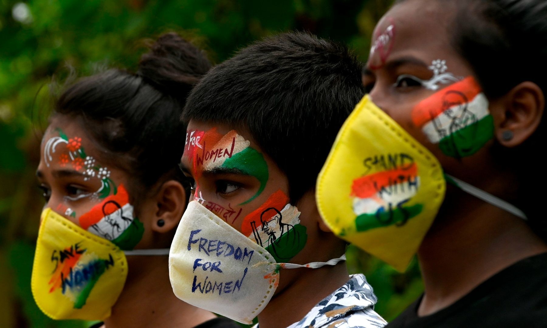 Students look on after getting their face painted to condemn the gang-rape a woman, in Mumbai on October 2. — AFP