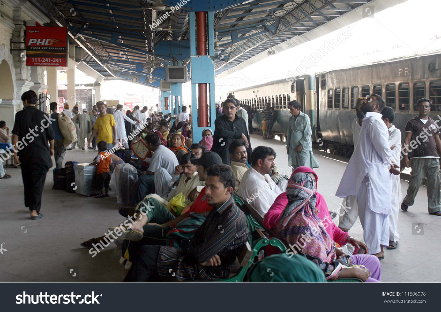 stock-photo-karachi-pakistan-aug-passengers-with-their-bags-gather-at-platform-as-trains-are-late-from-111506978.jpg