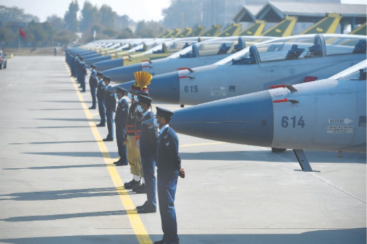 PERSONNEL of the Pakistan Air Force stand in a row near the 14 dual-seat JF-17B multi-role aircraft rolled out at a ceremony on Wednesday at the Pakistan Aeronautical Complex in Kamra.—AFP