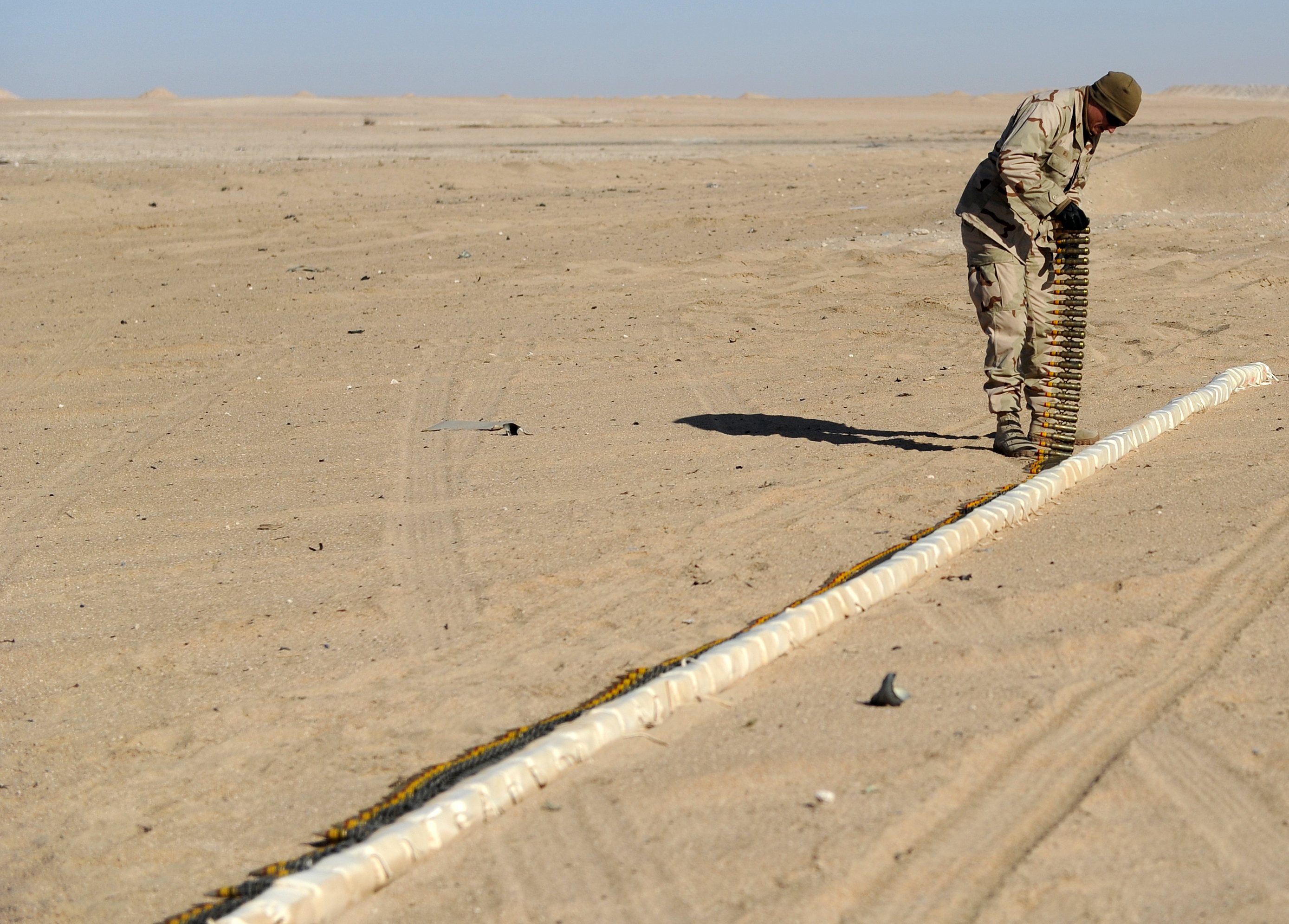 US_Navy_111213-N-BA263-028_Lt._j.g._Jacob_Mello,_assigned_to_Commander,_Task_Group_56.1,_prepares_25_mm_high-explosive_incendiary_rounds_for_dispos.jpg