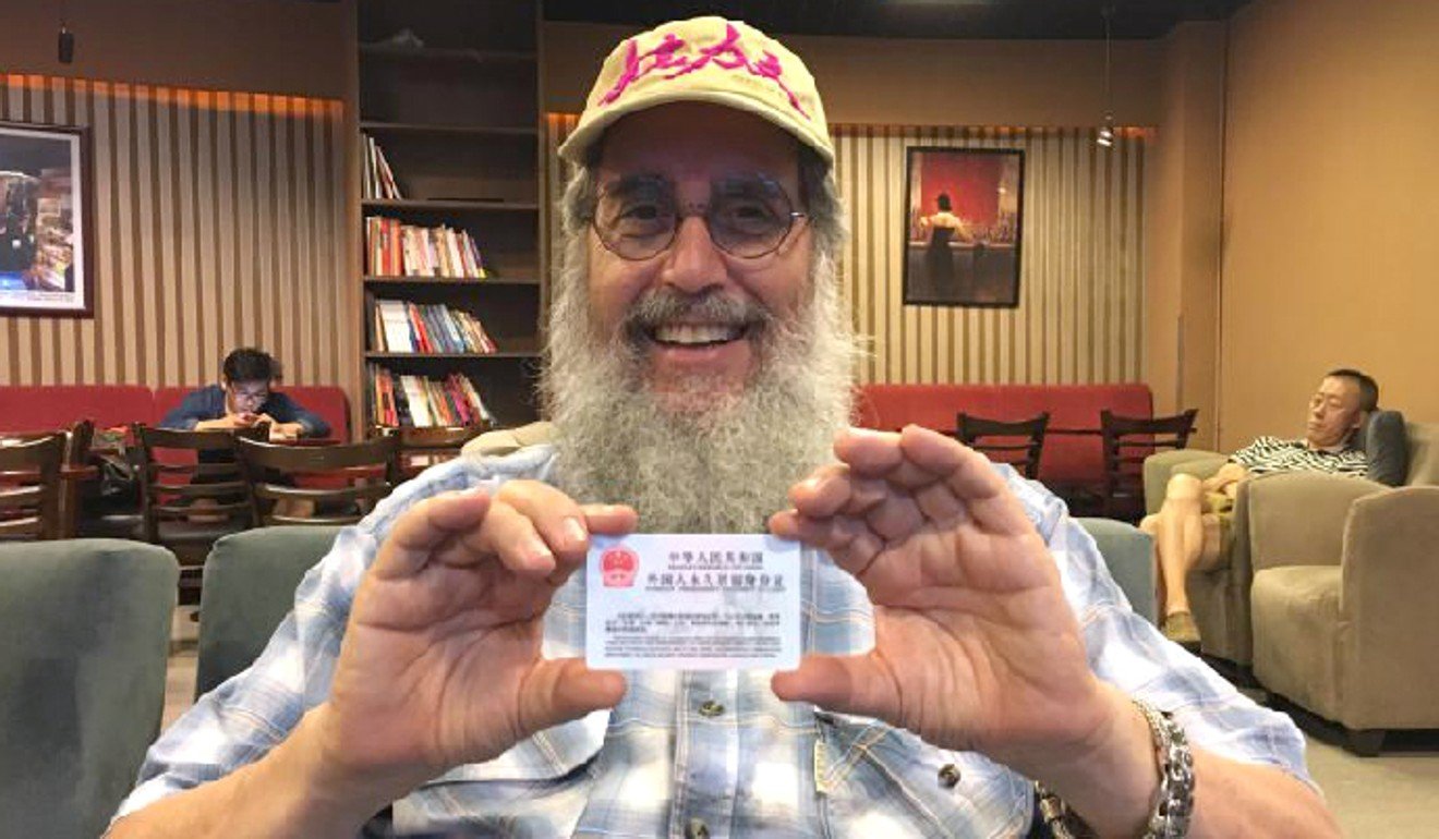 Mark Levine with his foreigner's permanent residence identity card, awarded in the summer of 2017, in Beijing. Photo: Xinhuanet