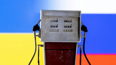 Model of petrol pump is seen in front of Ukraine and Russian flag colors in this illustration taken March 25, 2022. REUTERS/Dado Ruvic/Illustration/File Photo