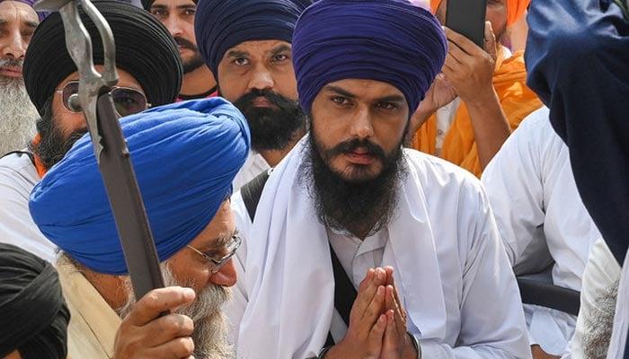 Chief of a social organisation, Amritpal Singh (C) along with devotees takes part in a Sikh initiation rite ceremony also known as ‘Amrit Sanskar’ at Akal Takht Sahib in the Golden Temple in Amritsar, India, on October 30, 2022. — AFP