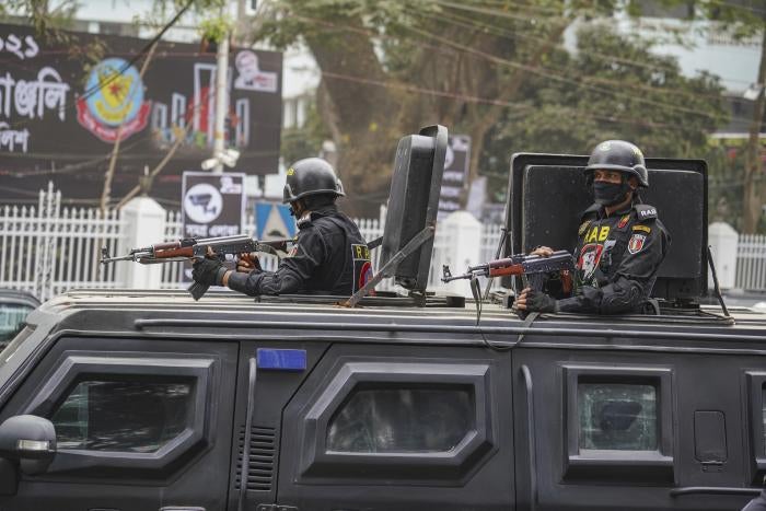 Rapid Action Battalion (RAB) officials stand alert inside a truck in front of Central Shaheed Minar in Dhaka, Bangladesh on February 20, 2021.