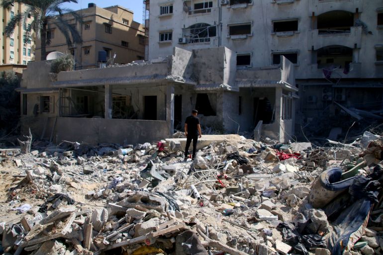 Palestinian citizens inspect damage to their homes caused by Israeli airstrikes